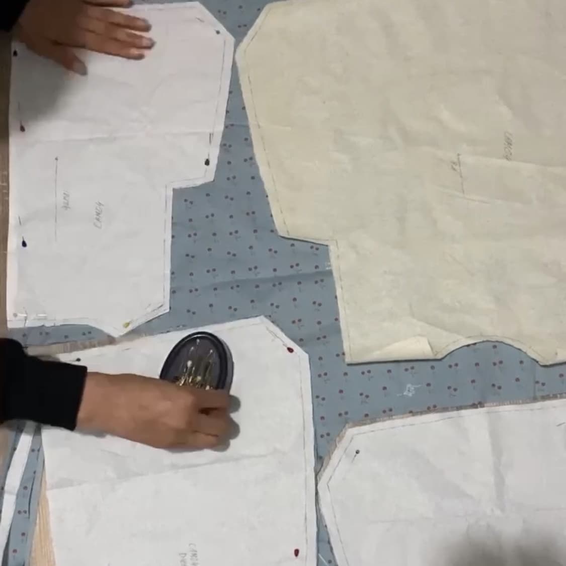 Paper patterns laid over the fabric before cutting