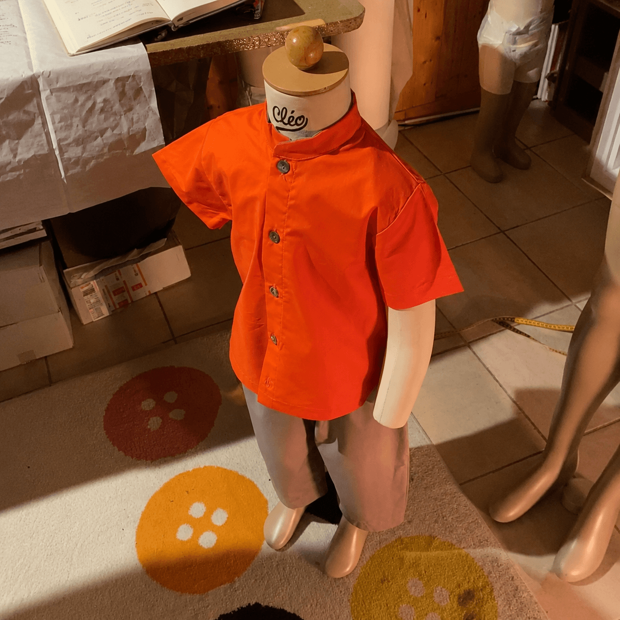 A boy's shirt on a mannequin in the workshop